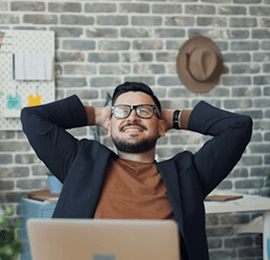 Person with glasses leaning back in his chair