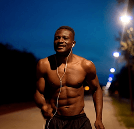 Person running outside at night listening to music